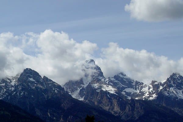 Mountain peaks emerging through clouds